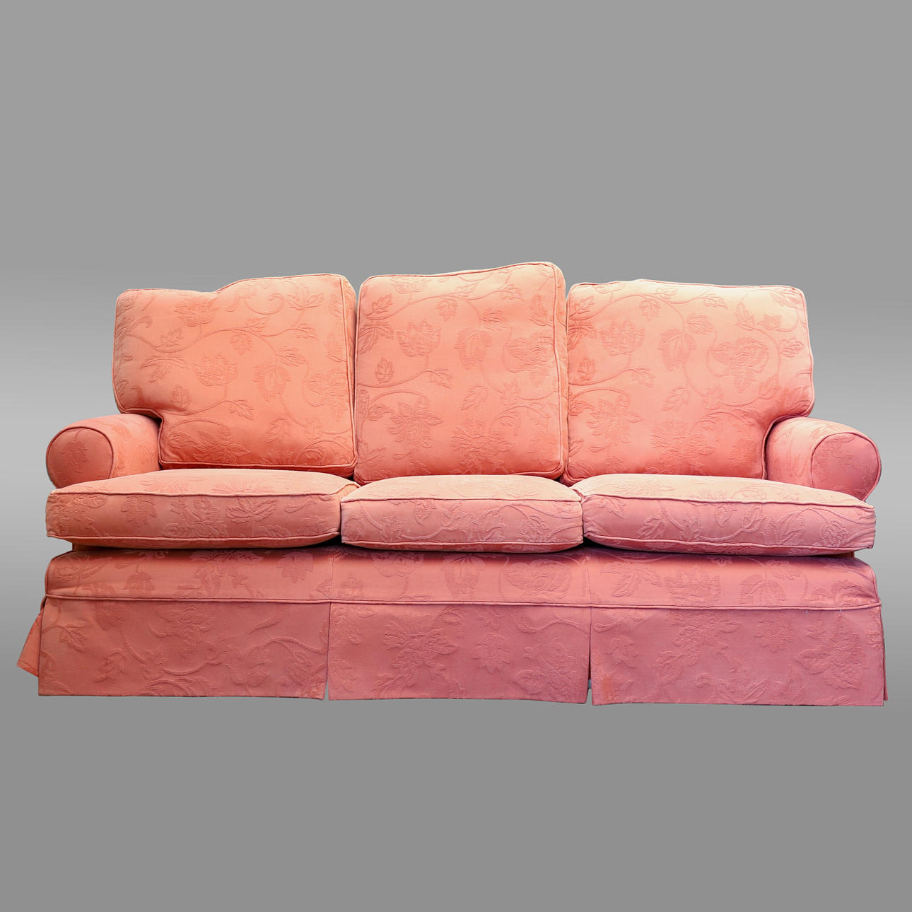 A MULTI-YORK THREE SEAT SOFA UPHOLSTERED IN RUST FLORAL FIGURED MATERIAL.