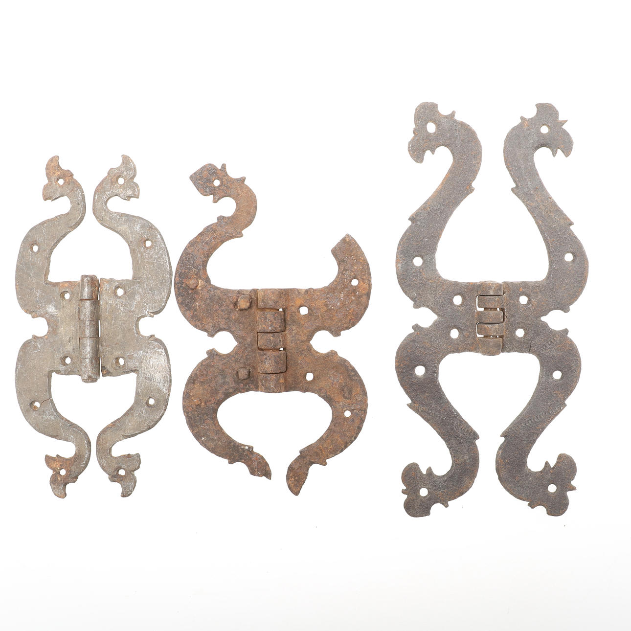 THREE DIFFERENT WROUGHT IRON COCK HEAD HINGES.