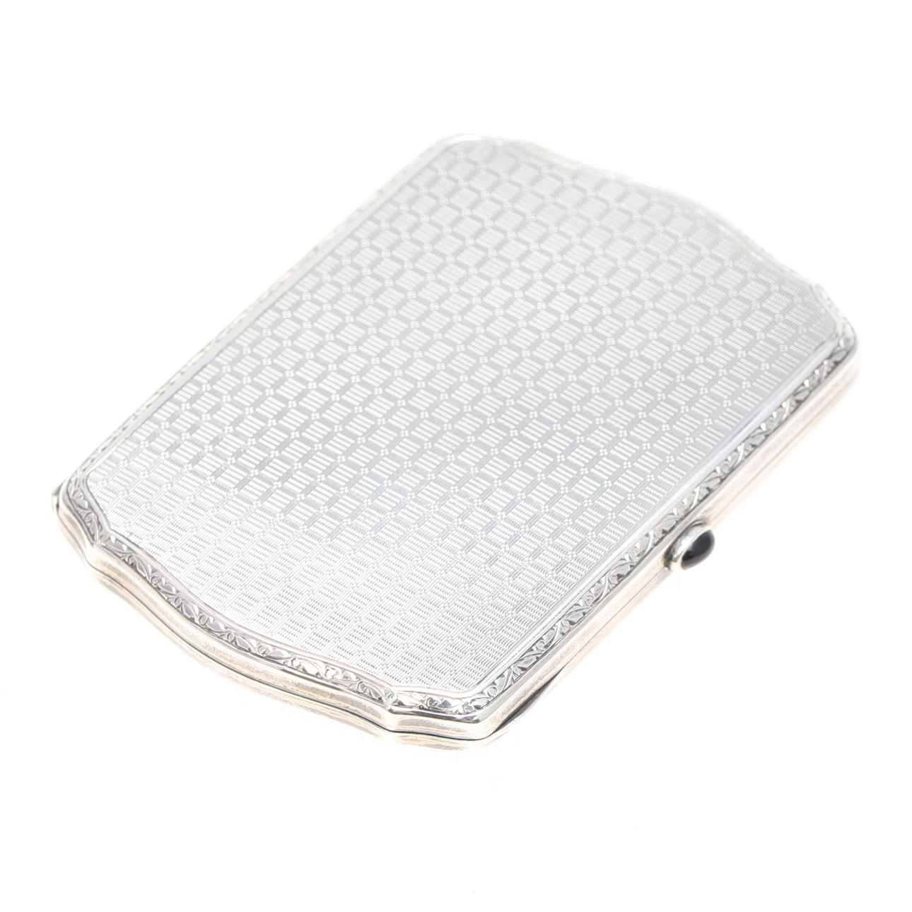 A SILVER CIGARETTE CASE WITH ENGINE TURNED DECORATION AND STONE SET CABOCHON THUMB PIECE.