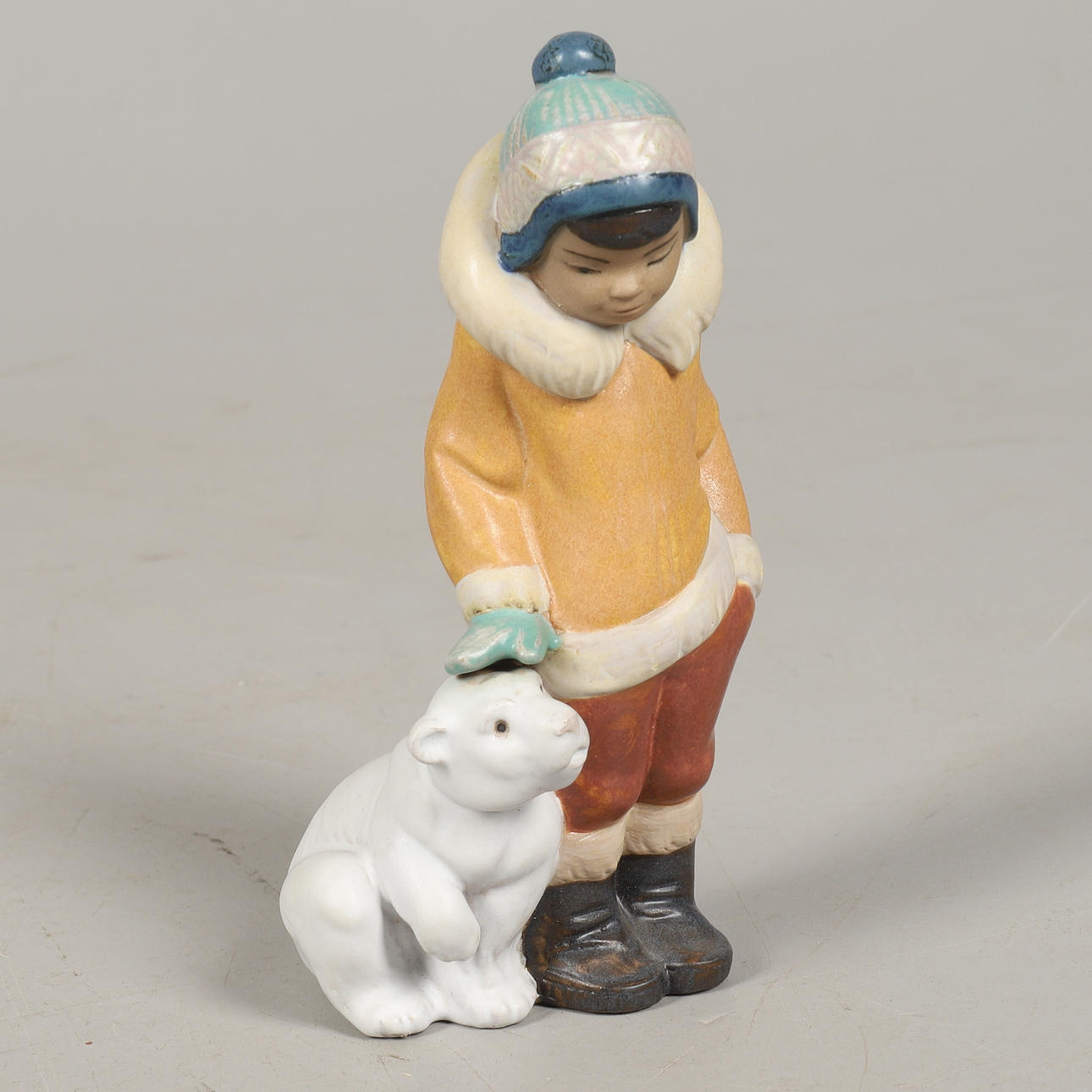 A LLADRO GRES FIGURE 2269, ESKIMO BOY WITH PET.