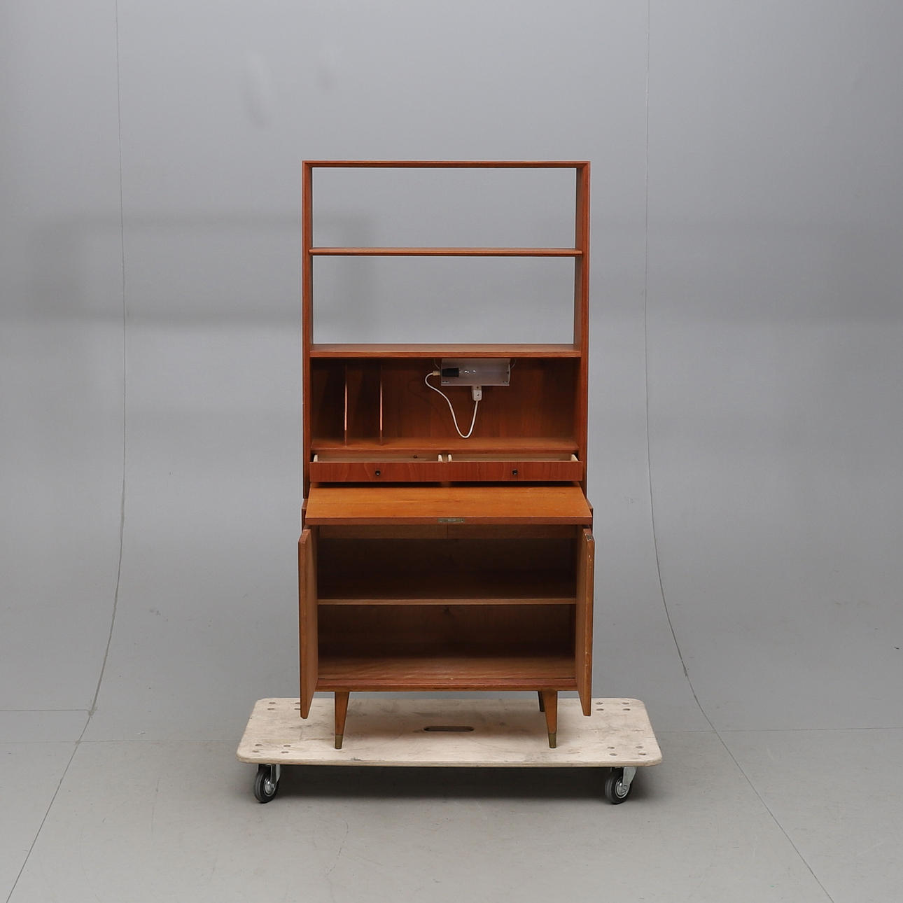 BOOK SHELF, with writing flap, veneered in teak, around the middle of ...