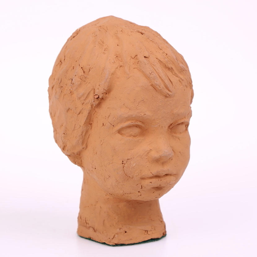 NILS CASTEGREN. Skulptur i terrakotta, barnhuvud, signerad.