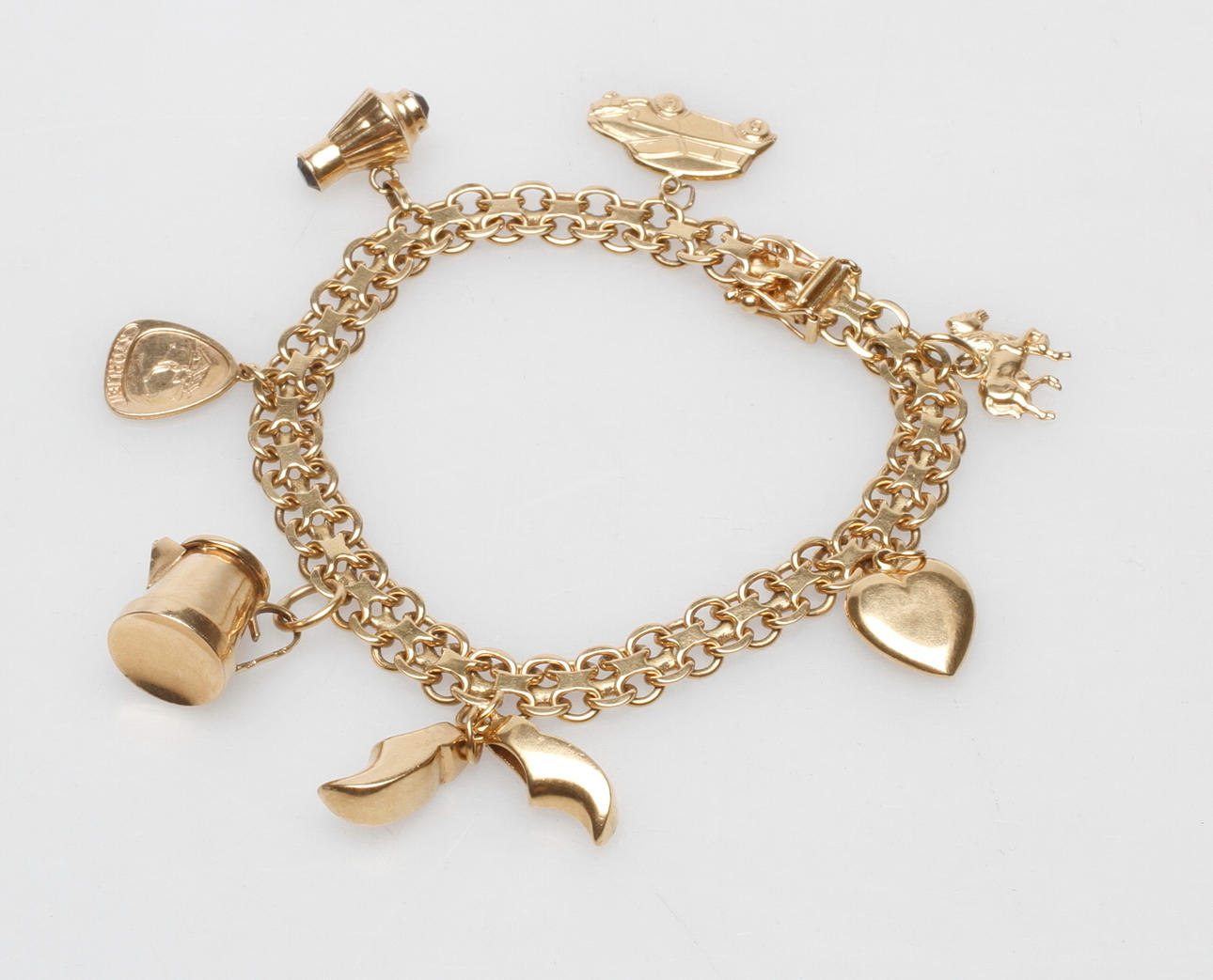 ARMBAND X-LÄNK MED BERLOCKER, 18k guld, total vikt 25,8 gr.