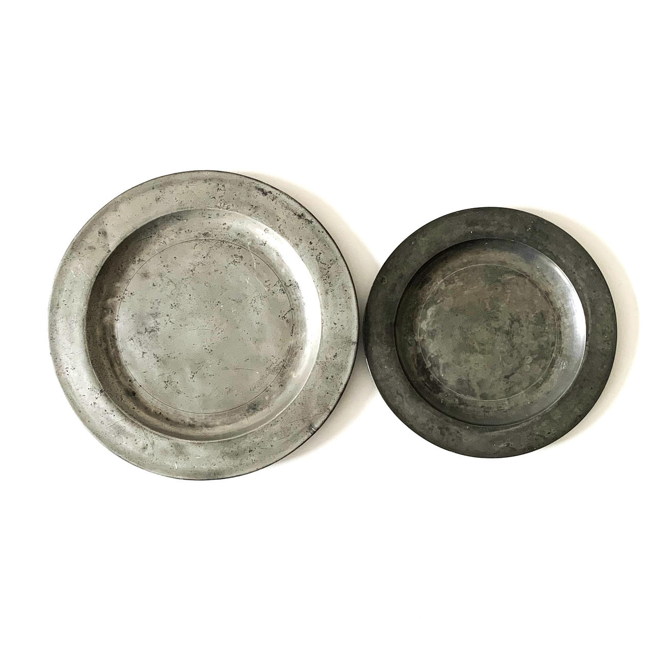 TWO LARGE PEWTER PLATES.