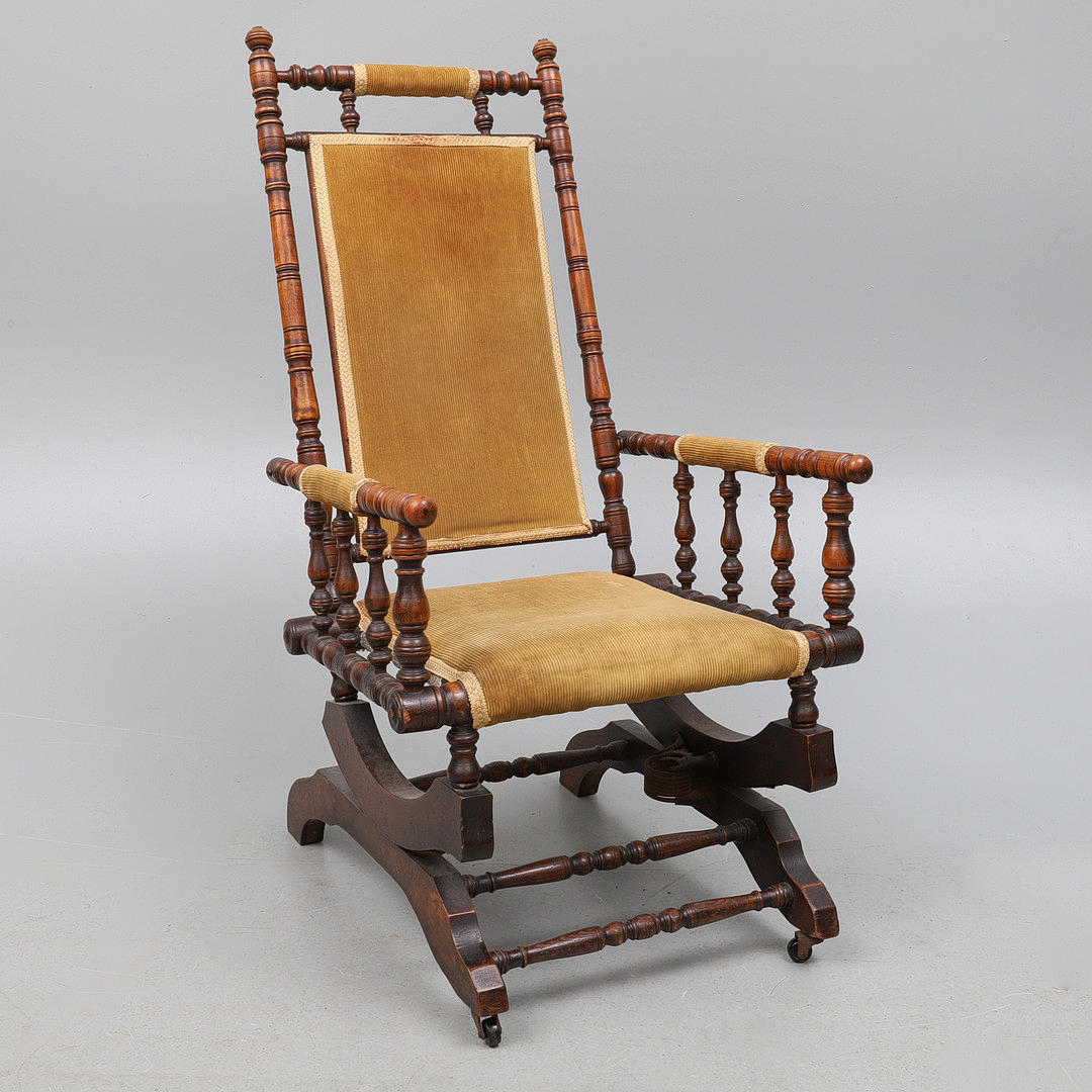 A LATE VICTORIAN RING TURNED WALNUT FRAME ROCKING CHAIR.