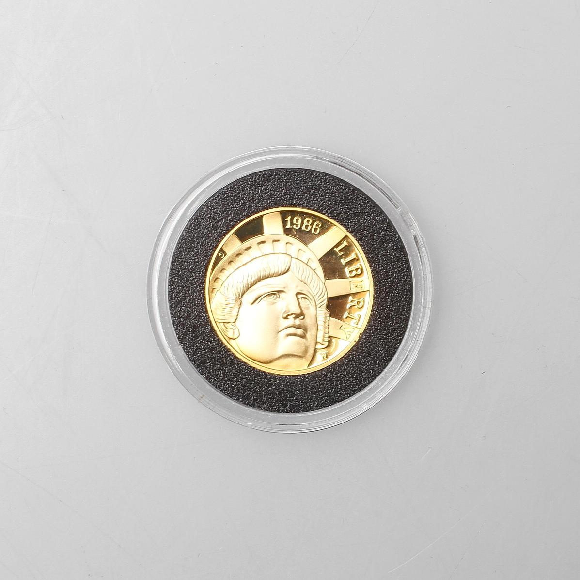 GULDDOLLAR, Frihetsstatyn 100 år, vikt ca. 8,36 gram.