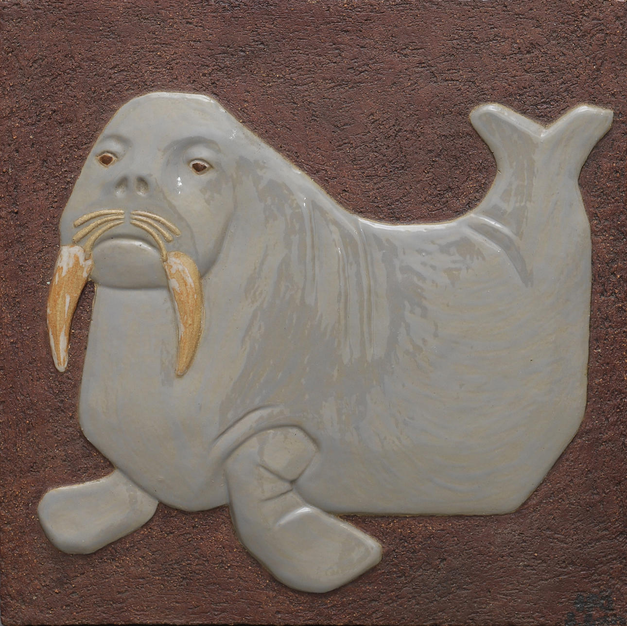 RELIEF SHOWING VALRUS, PARTIALLY GLAZED CERAMIC.