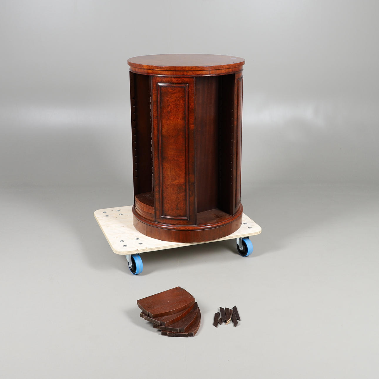 A REPRODUCTION WALNUT REVOLVING BOOKCASE.