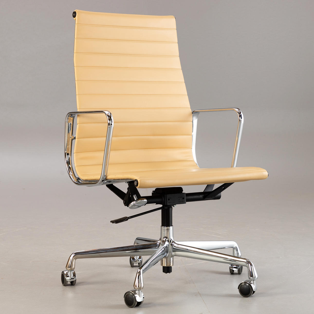 RAY & CHARLES EAMES. Vitra. Office chair 'EA 119', cream-colored vinyl ...