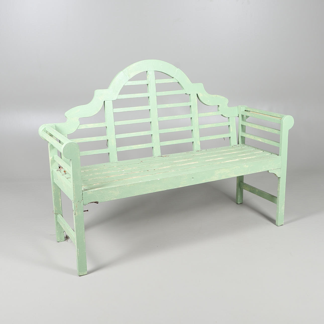 A GREEN PAINTED GARDEN BENCH.