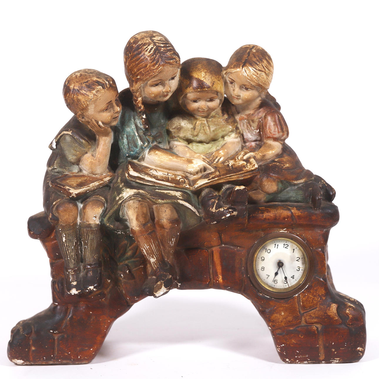 TABLE CLOCK. CHILDREN READING. PATINATED STUCCO.