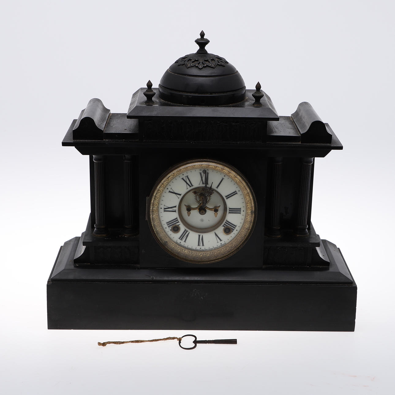 A BLACK SLATE MANTEL CLOCK.