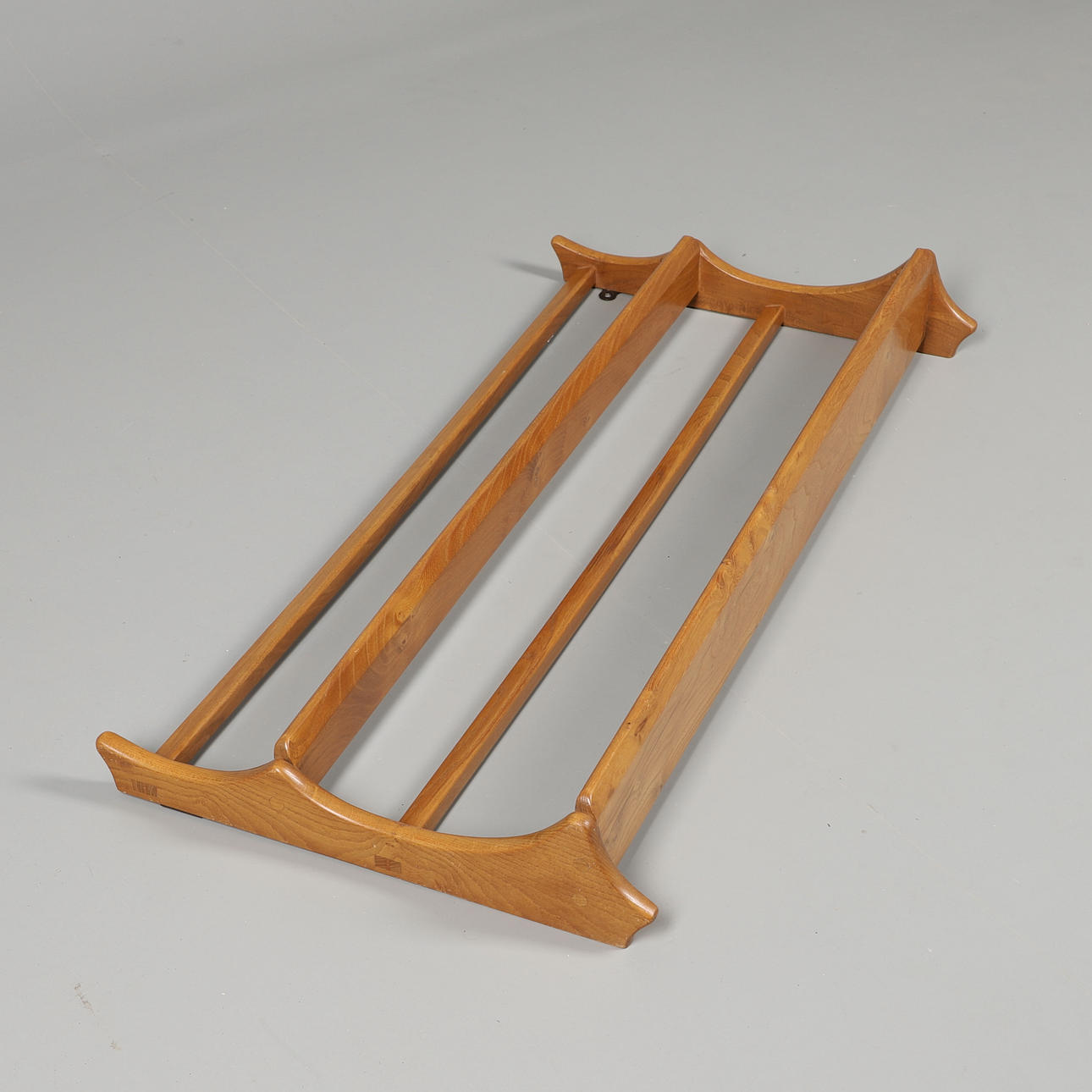 A SET OF ERCOL WALL MOUNTED SHELVES.