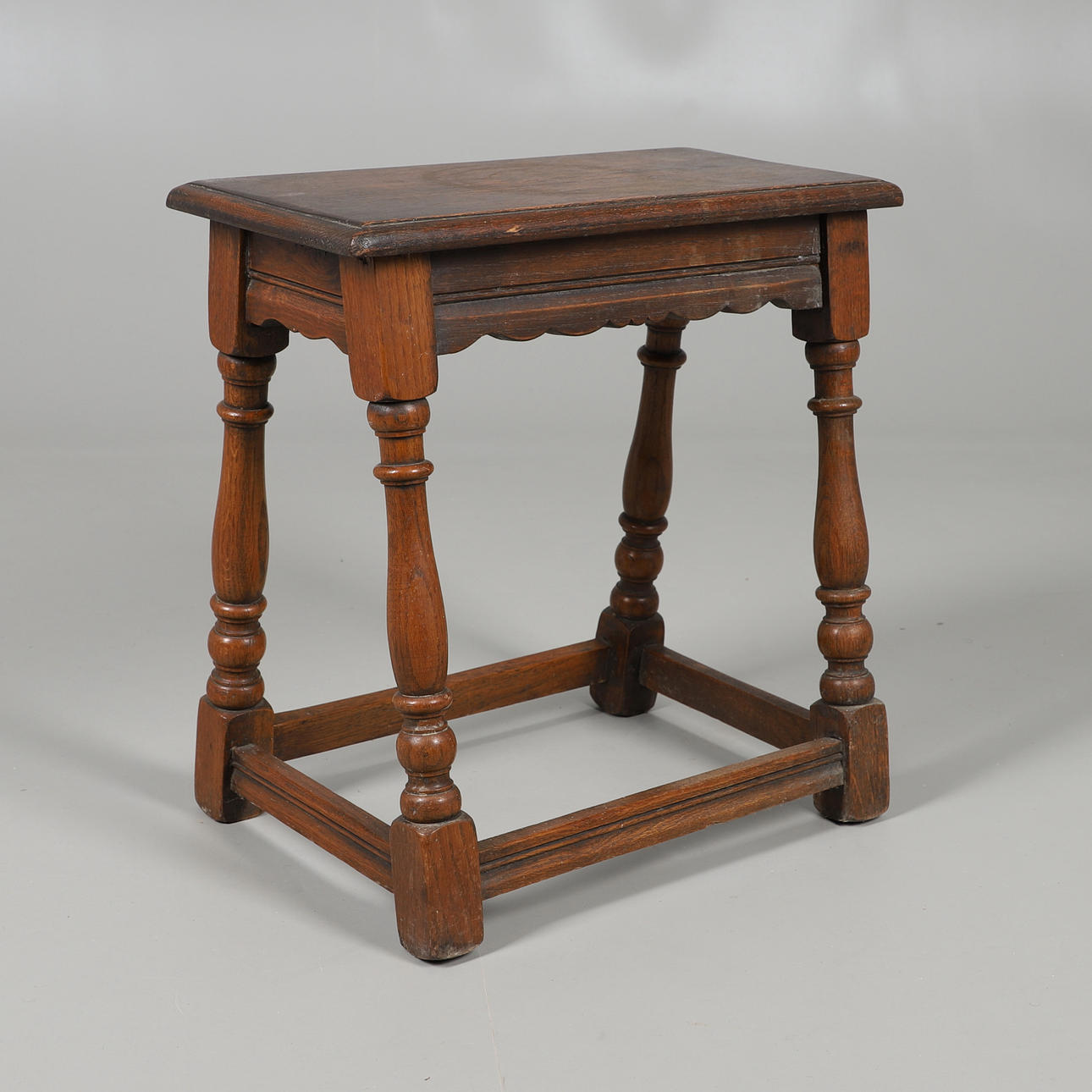 AN OAK COFFIN STOOL.