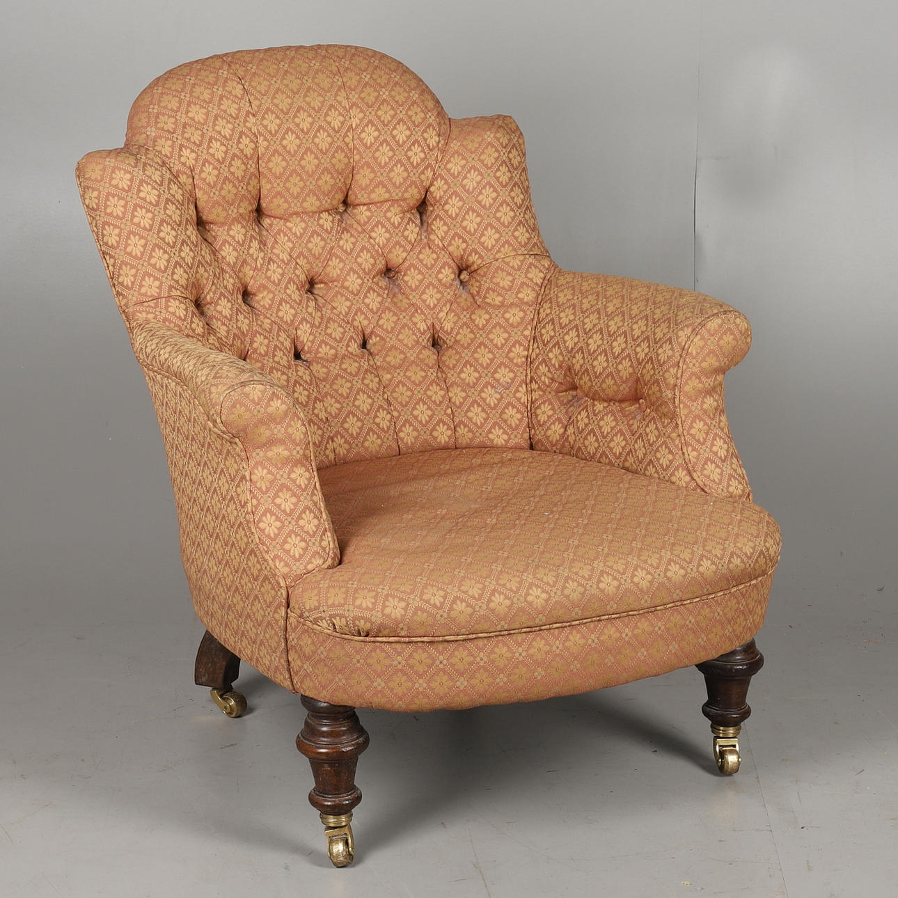 A VICTORIAN BUTTON BACK ARMCHAIR.