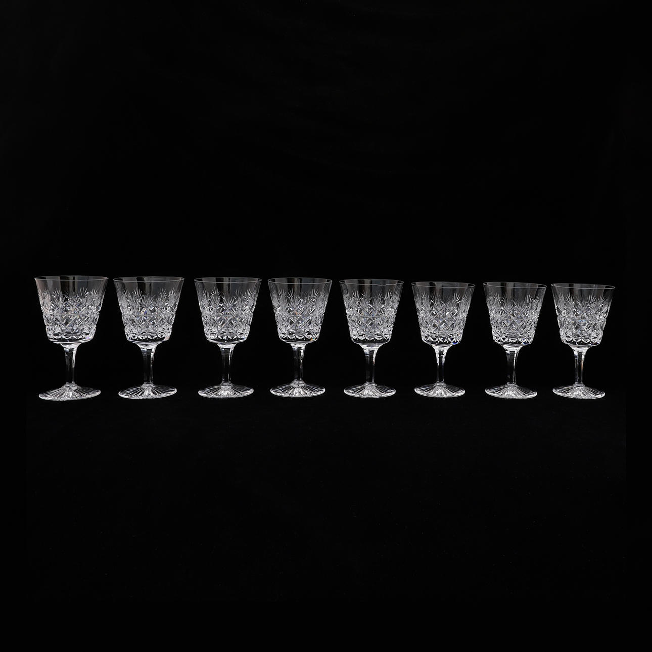 A SET OF EIGHT STUART CUT PATTERN WINE GLASSES.