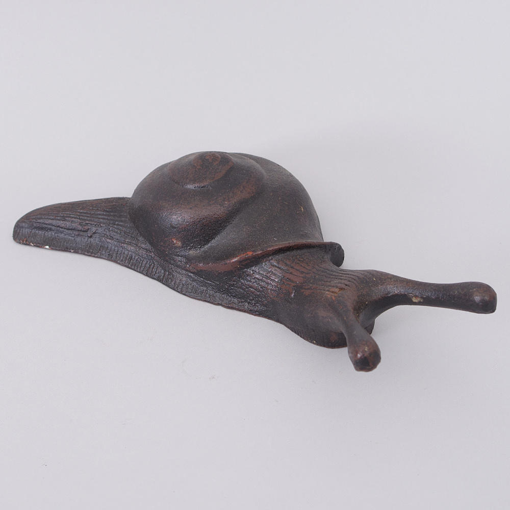 STÖVELKNEKT i form av snigel, gjutjärn, samtida.