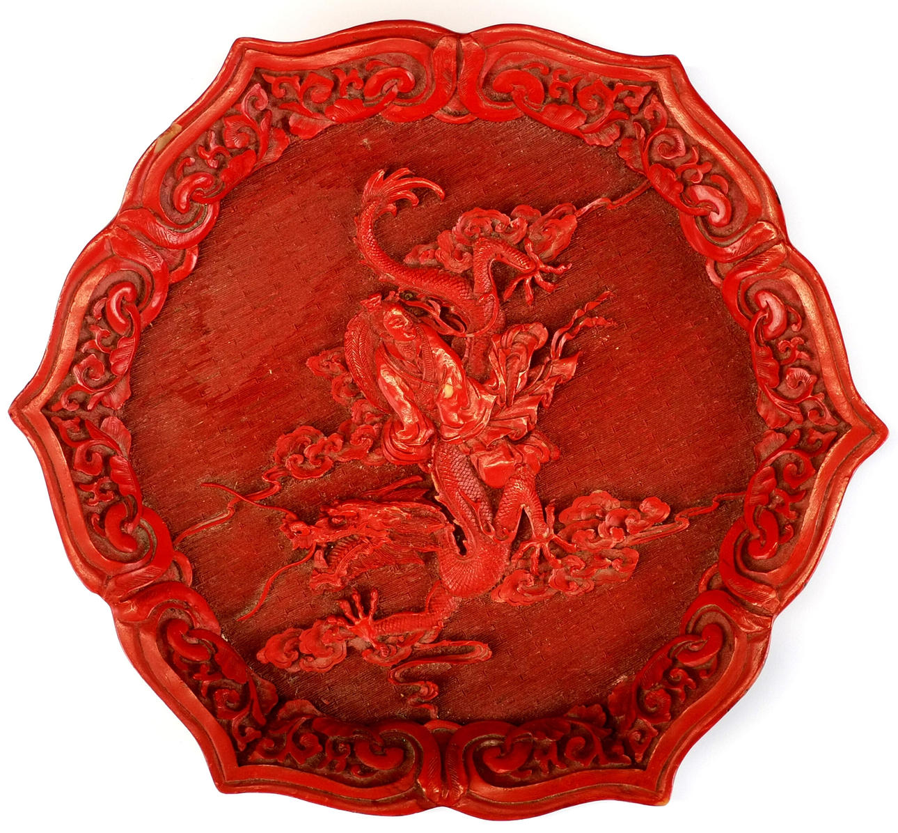 CHINESE RELIEF DECORATED CINNABAR STYLE PLATE.