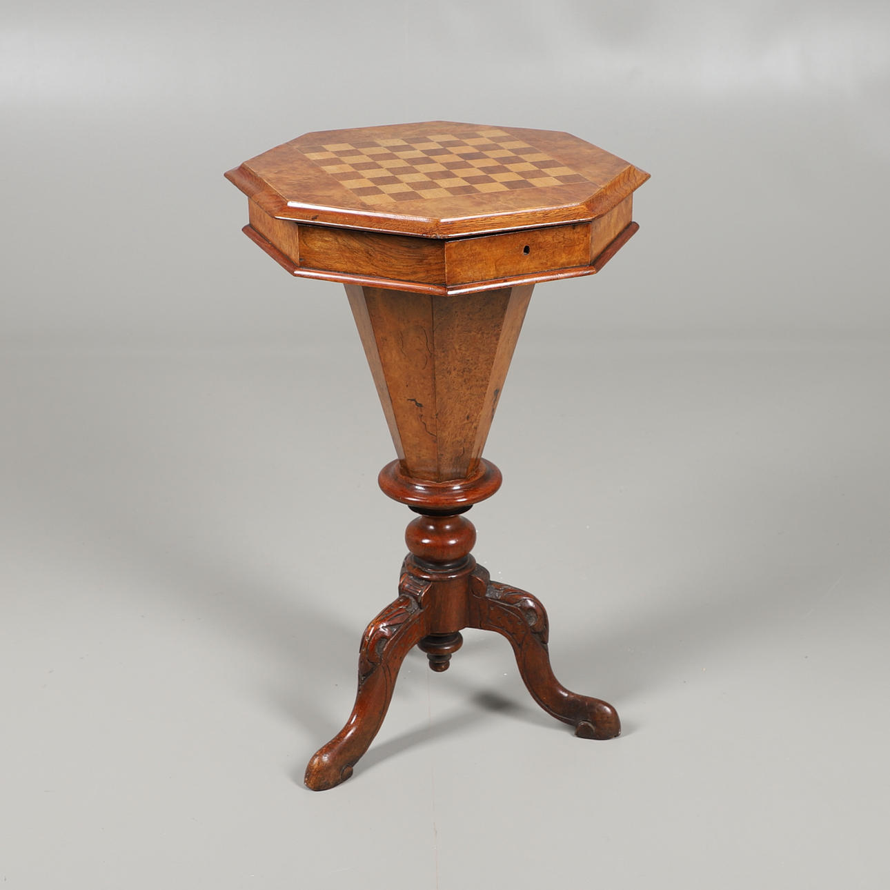 AN OCTAGONAL WALNUT GAMES TABLE.