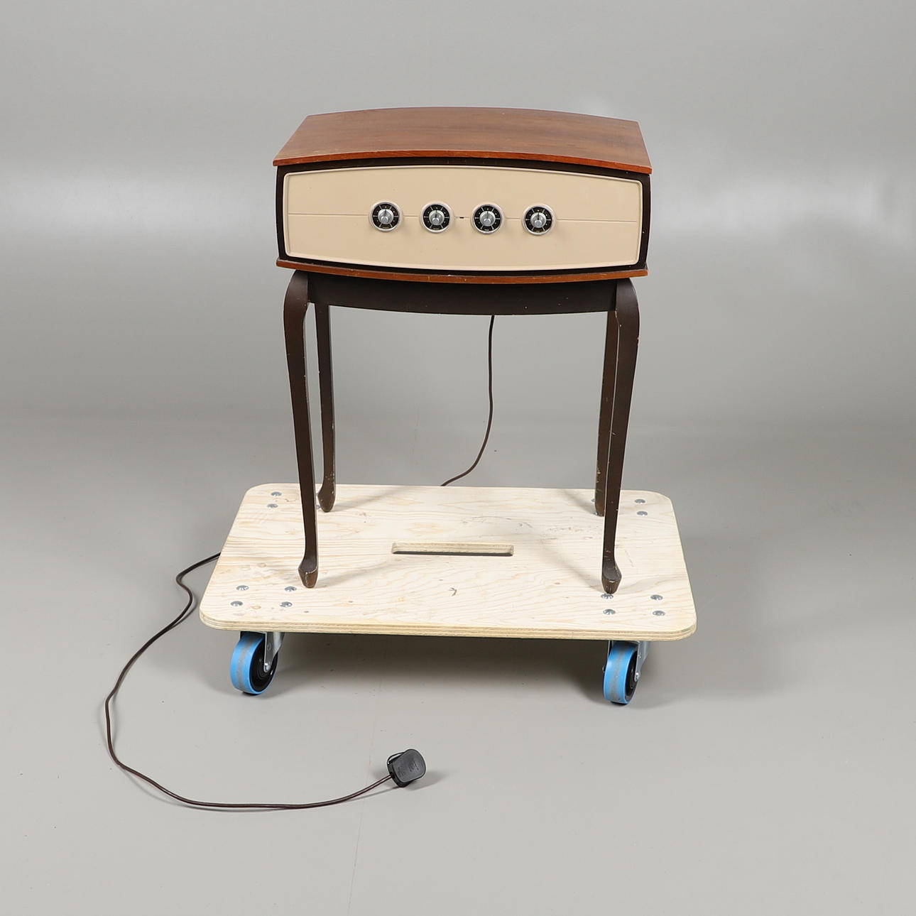 A PYE VINTAGE RECORD PLAYER ON STAND.