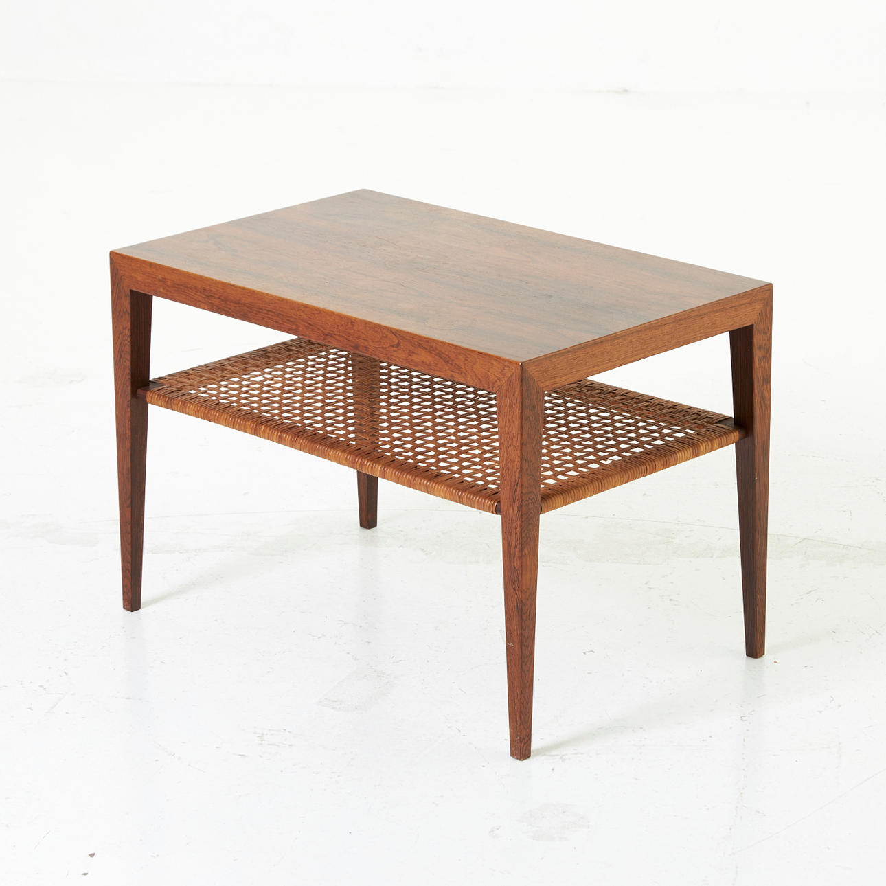 SEVERIN HANSEN. Coffee table, "Model 43", jacaranda, rattan shelf, labeled, Haslev Møbelfabrik, Denmark, 1960s.