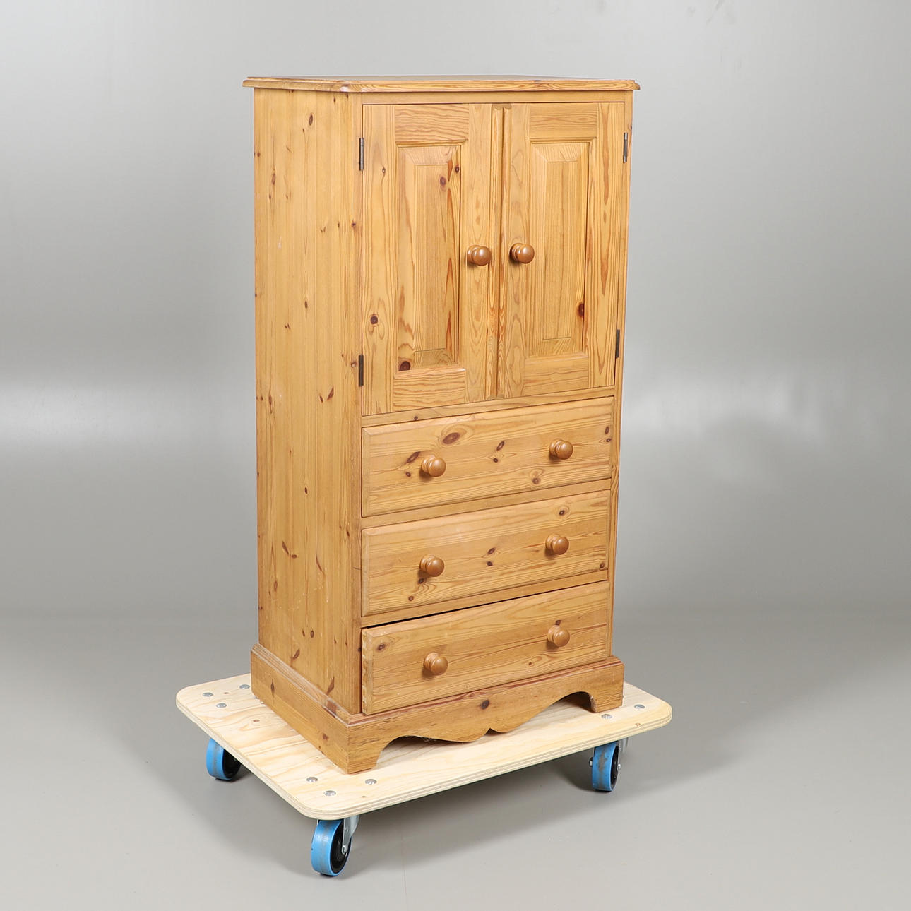 A TALL PINE CUPBOARD.