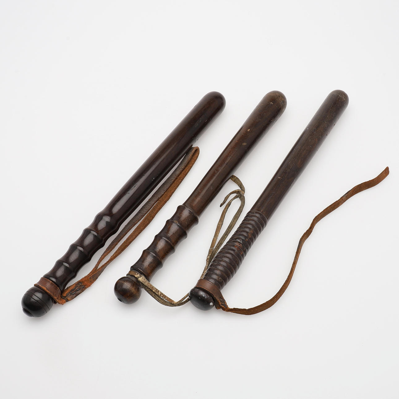 POLICE BATONS, THREE PIECES.