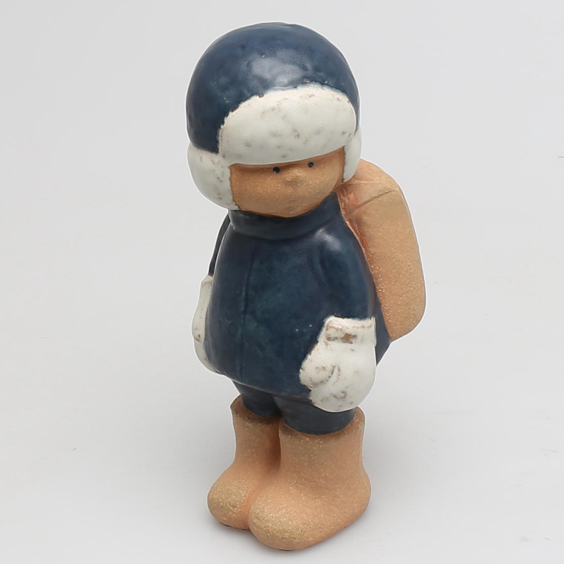 LISA LARSON. Figurin i stengods, pojke med ryggsäck, Gustavsberg, efter 1980.