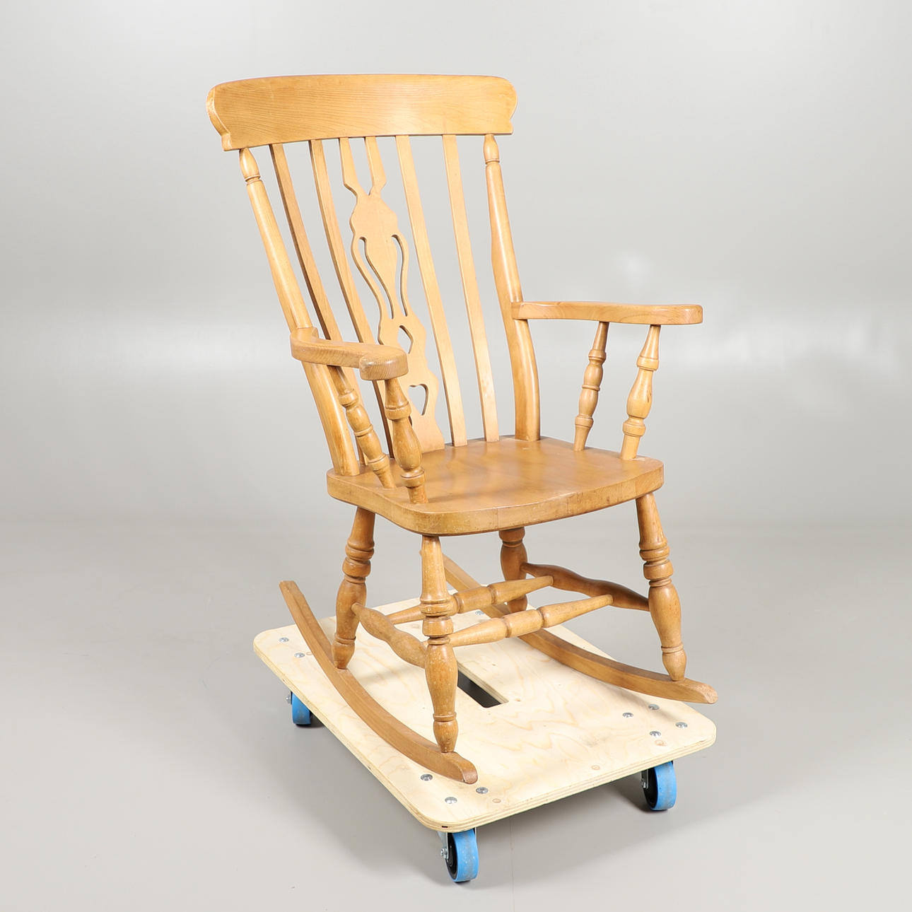A PINE ROCKING CHAIR.