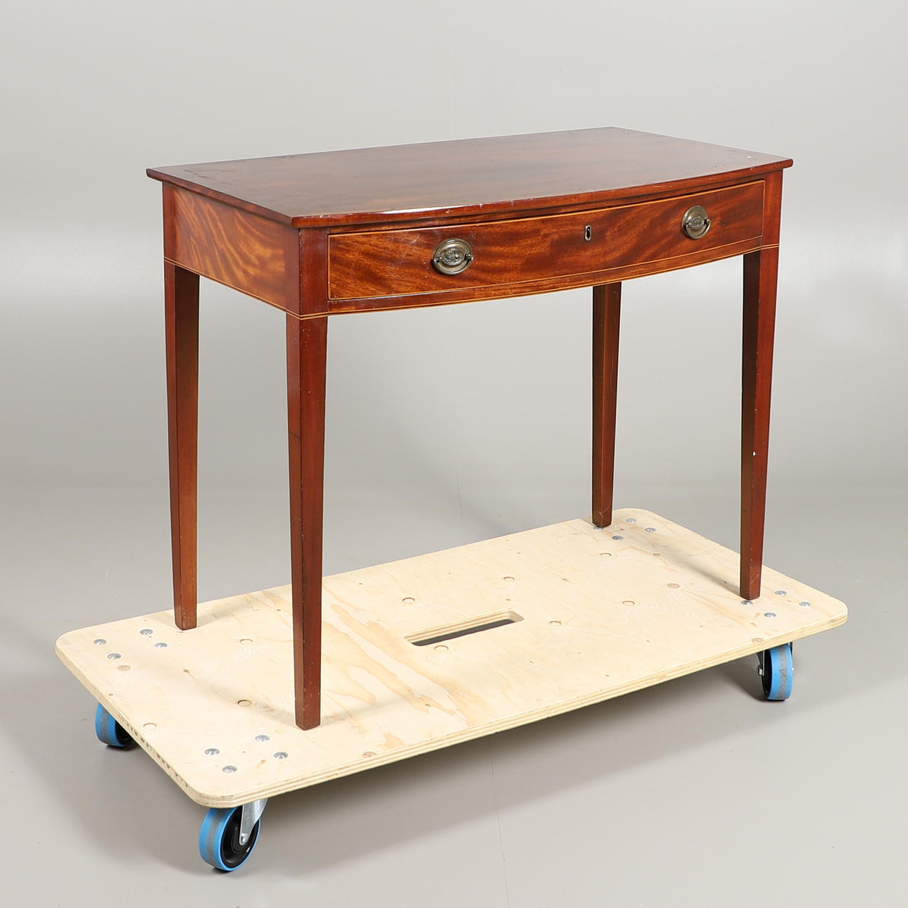 A MAHOGANY BOW FRONTED SIDE TABLE.
