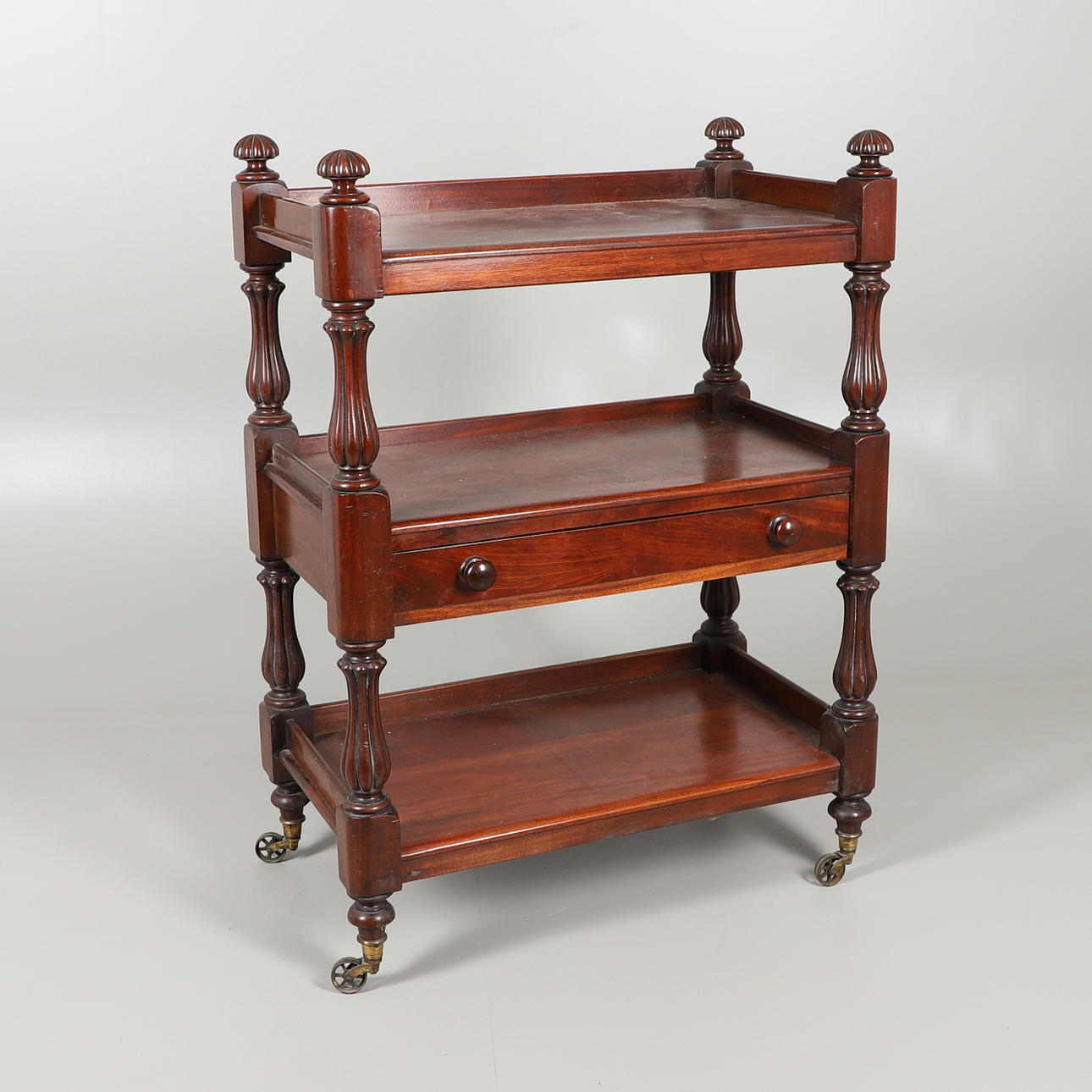 A VICTORIAN MAHOGANY THREE TIER BUFFET.