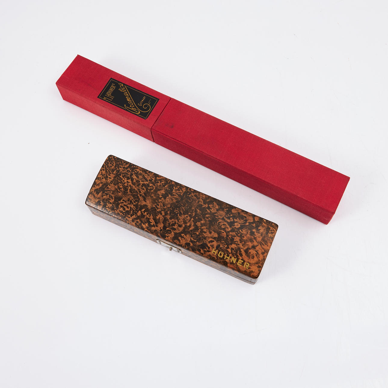 HOHNER, harmonica, 2 pcs, The 64 Chromonica as well as M. Hohner's Chromatica, numbered 280 and 263 respectively, both in original case, the former in wooden case the latter in cardboard case covered in red ball.