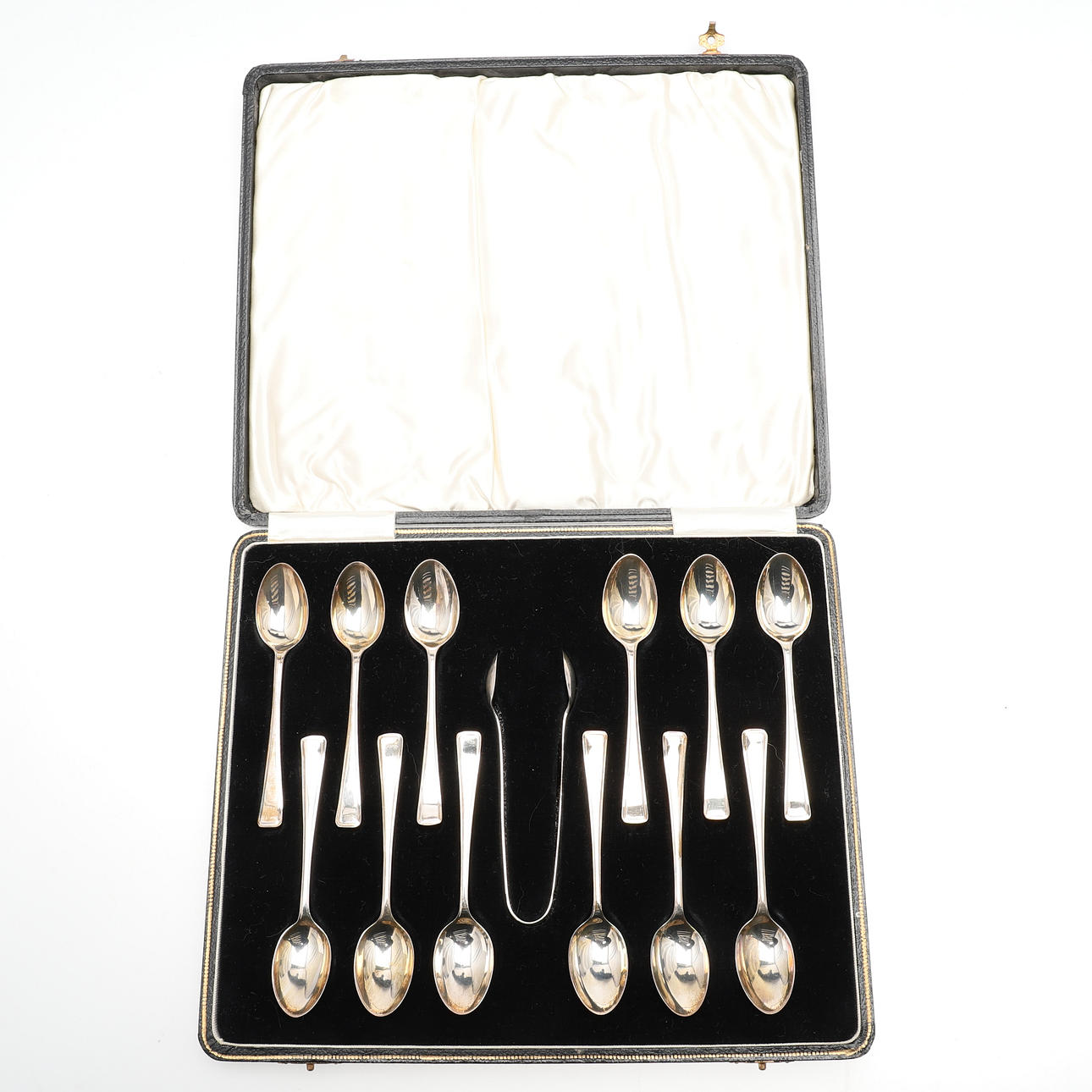 A CASED SET OF TWELVE SILVER TEASPOONS AND TONGS.