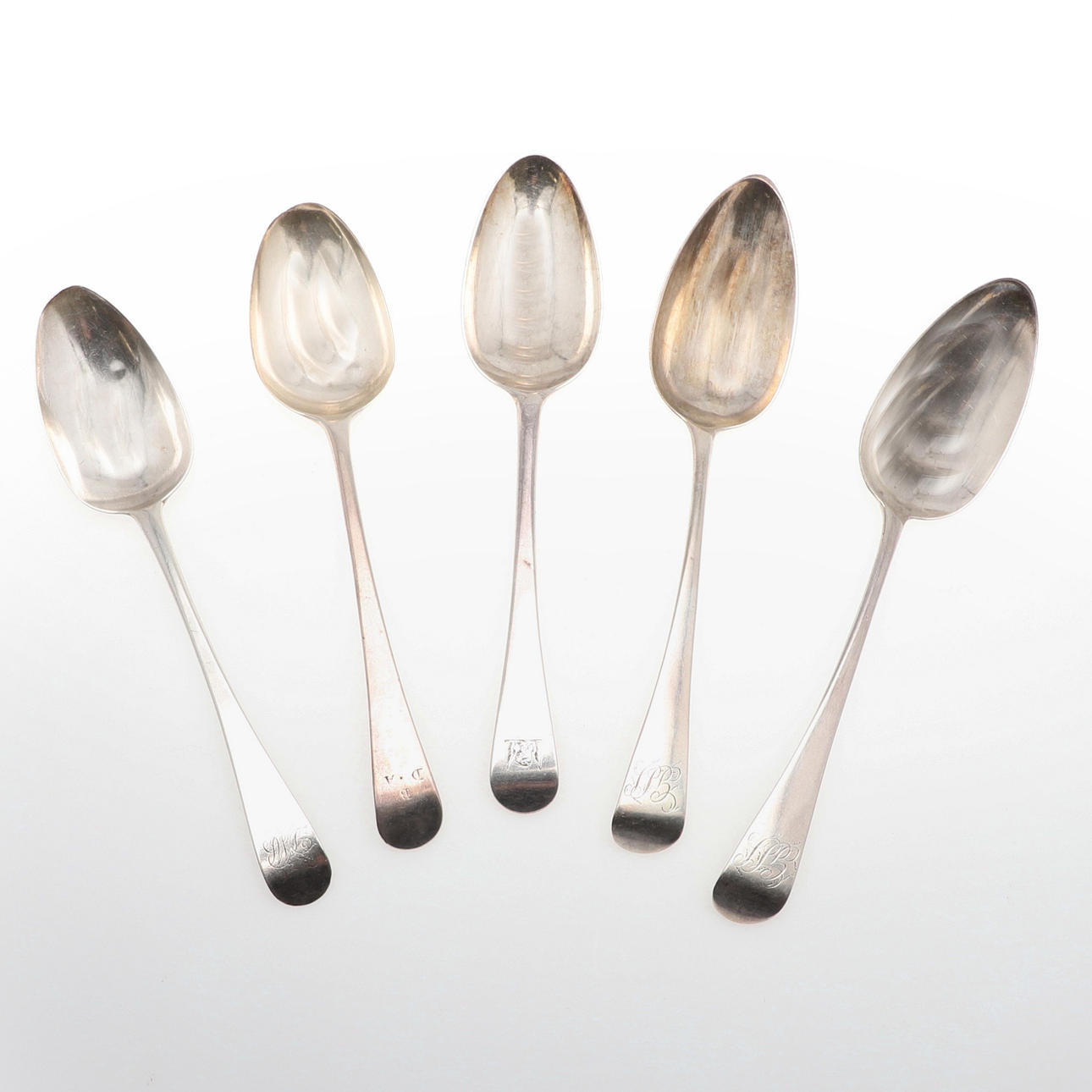 FIVE VARIOUS SILVER SERVING SPOONS.