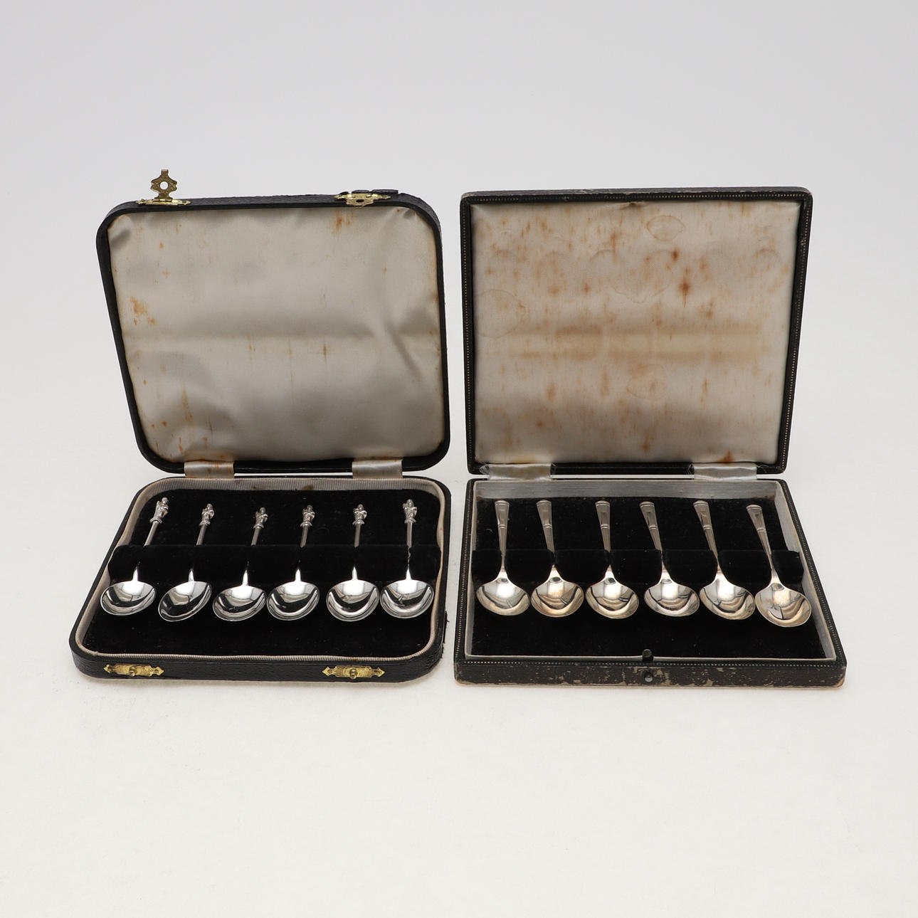 TWO CASED SET OF SILVER SPOONS.