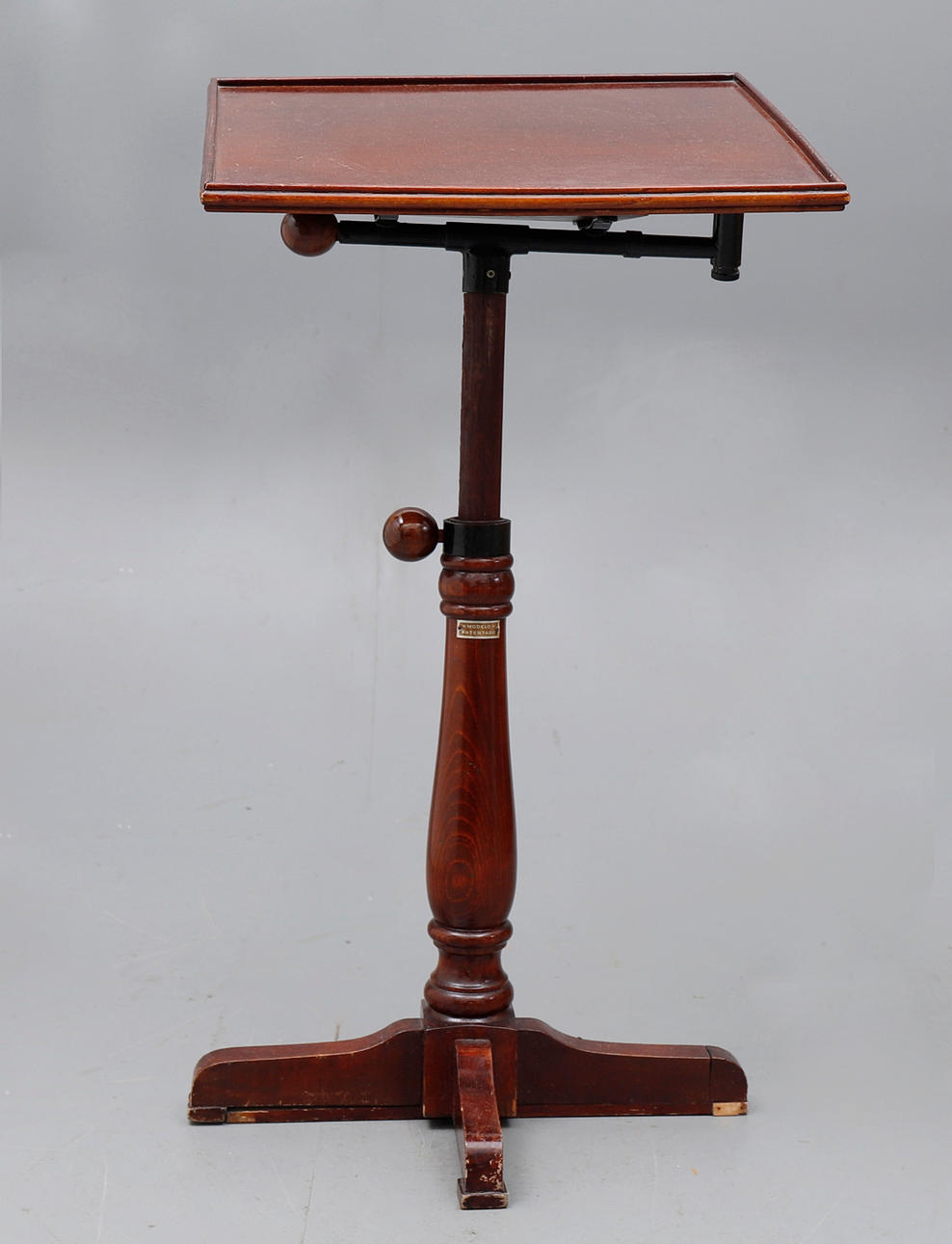 Reading side table in stained and turned beech, 20th Century.