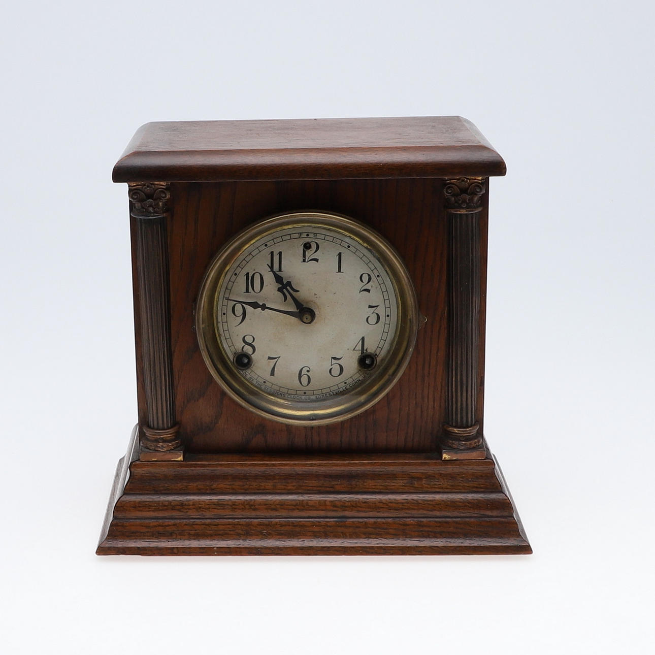 AN OAK MANTLE CLOCK.