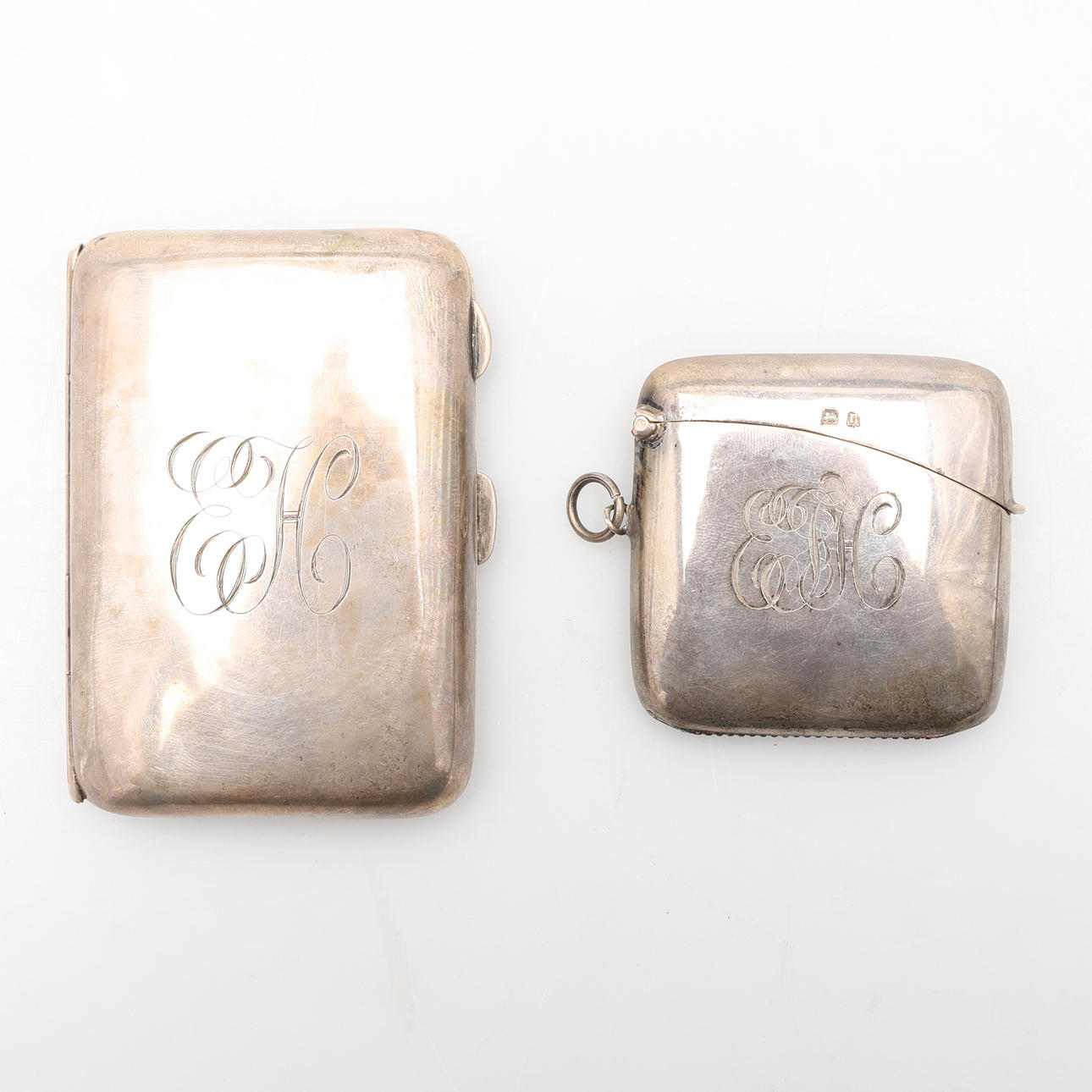 A LARGE SIZE SILVER VESTA CASE AND A SILVER CIGARETTE CASE.