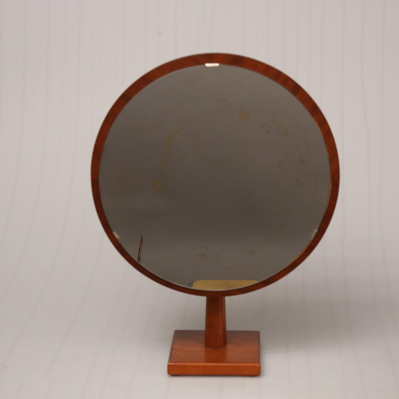 TABLE MIRROR, on a wooden stand, labeled G&T.