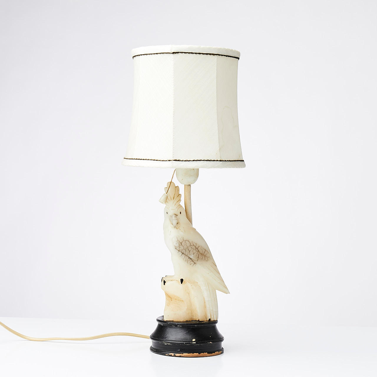 TABLE LAMP, in the shape of a cockatoo, probably Italy, alabaster and wooden base and textile shade.