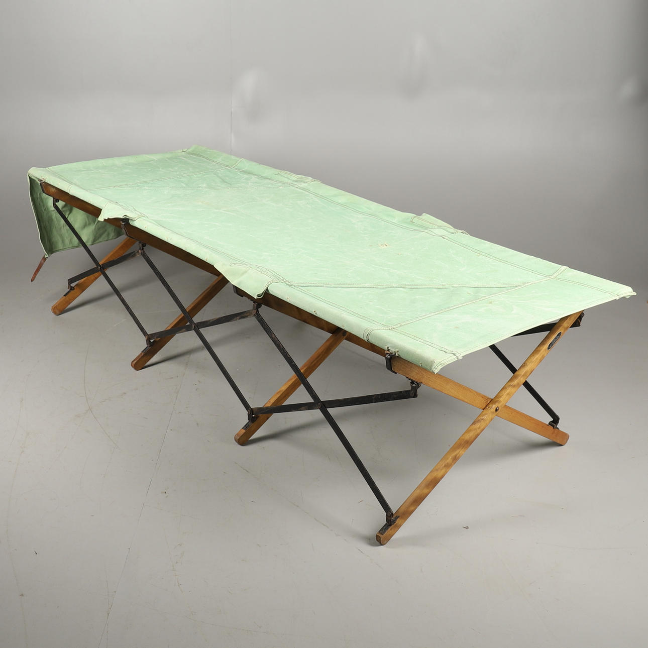 A VINTAGE FOLDING CAMP BED.