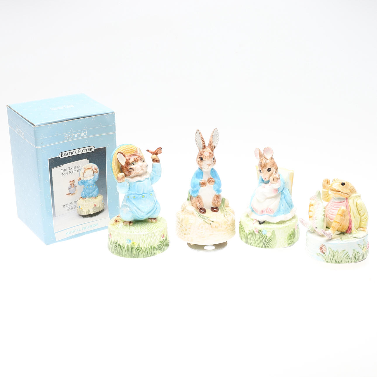 FOUR BEATRIX POTTER MUSICAL CHINA FIGURINES.