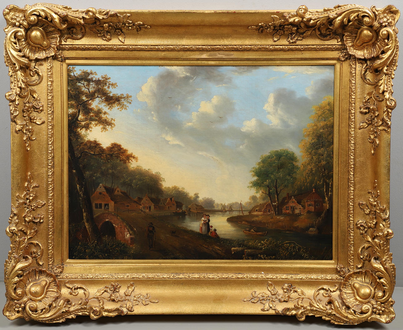 FOLLOWER OF JULIUS CAESAR IBBETSON (1759-1817). FIGURES AT A RURAL RIVERSIDE VILLAGE.