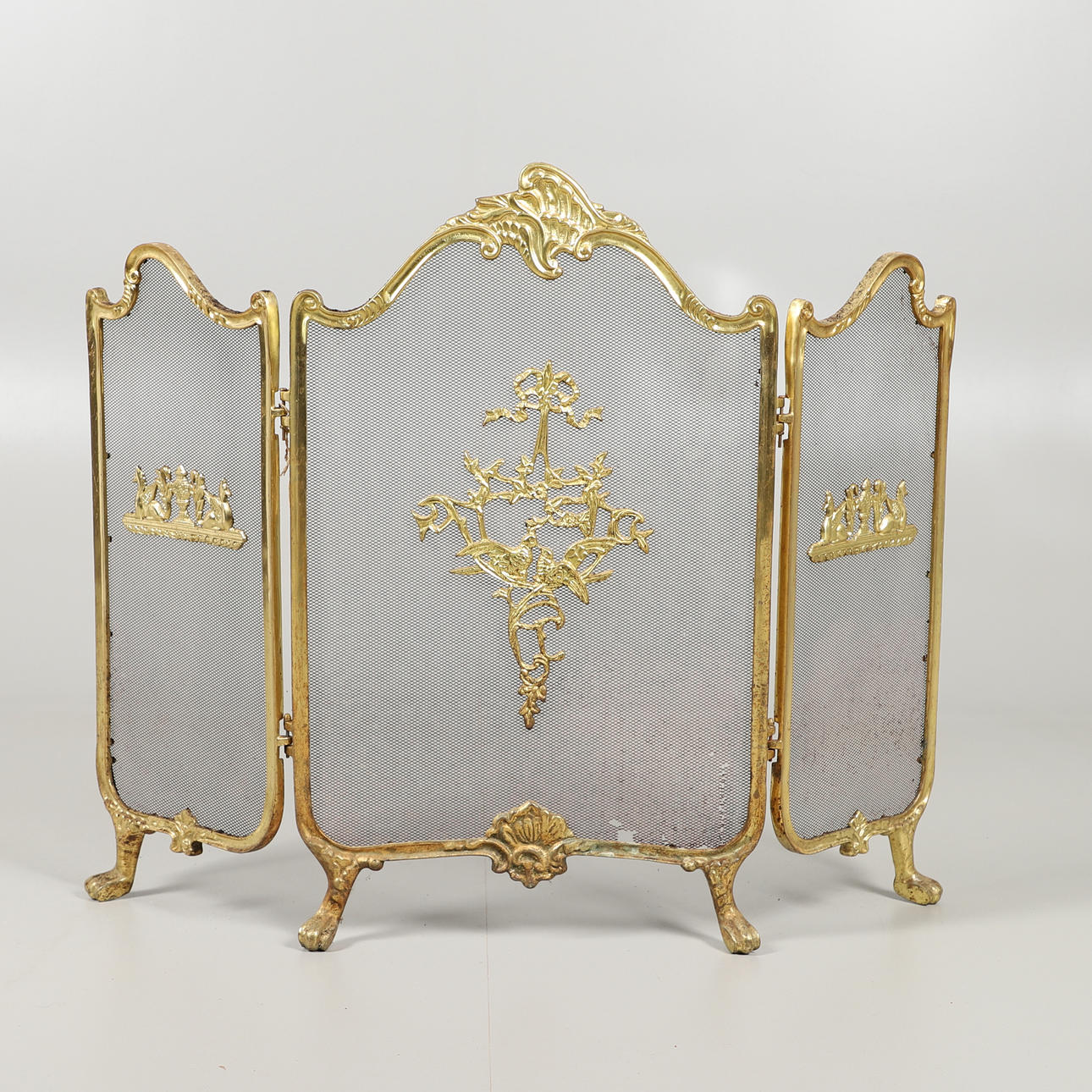 A FRENCH BRASS SPARK GUARD.