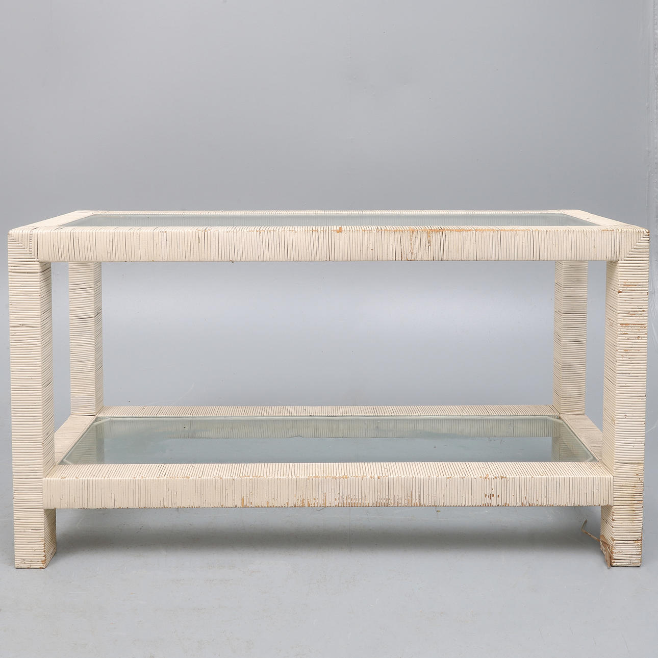 A VINTAGE CREAM PAINTED RATAN TWO TIER RECTANGULAR CONSOLE TABLE.