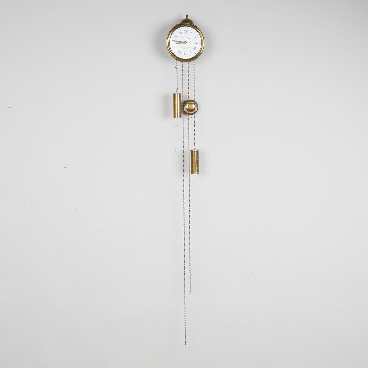 Wall clock / pendulum clock, 'Le Temps de Liege', brass, 20th century.