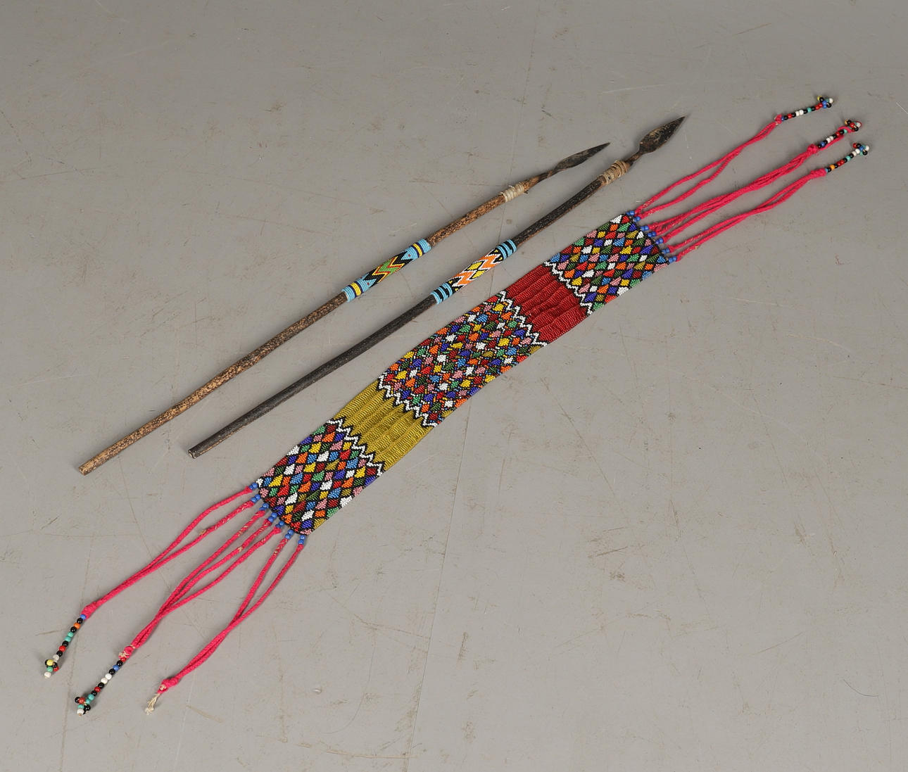 A ZULU BEADWORK PANEL AND TWO SPEARS.