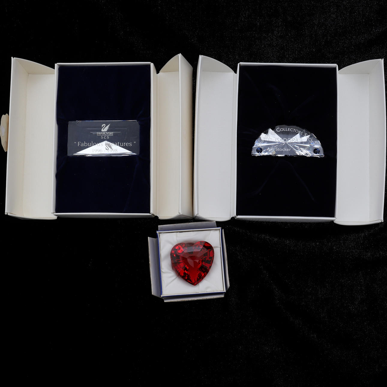 SWAROVSKI: TWO TITLE PLAQUES AND A RED HEART.