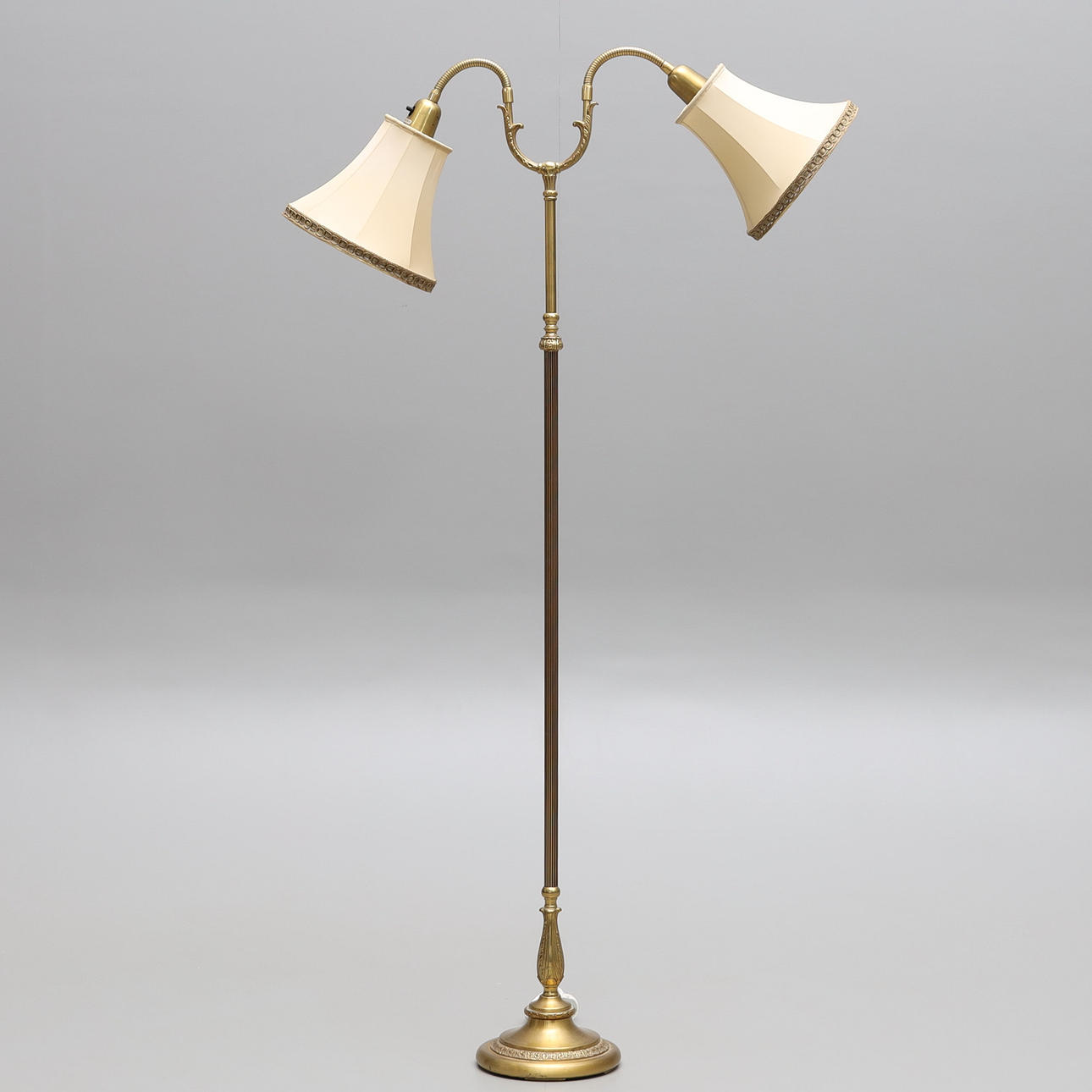 FLOOR LAMP, two-armed, brass, mid-20th century.
