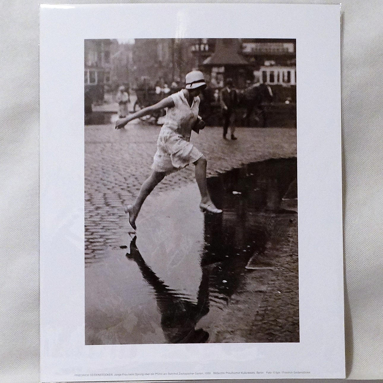 FRIEDRICH SEIDENSTÜCKER. Woman jumping over a puddle in